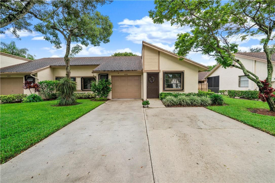8046 Summerview Terrace Boca Raton, FL 33496 - Photo 2 of 25 a front view of a house with garden
