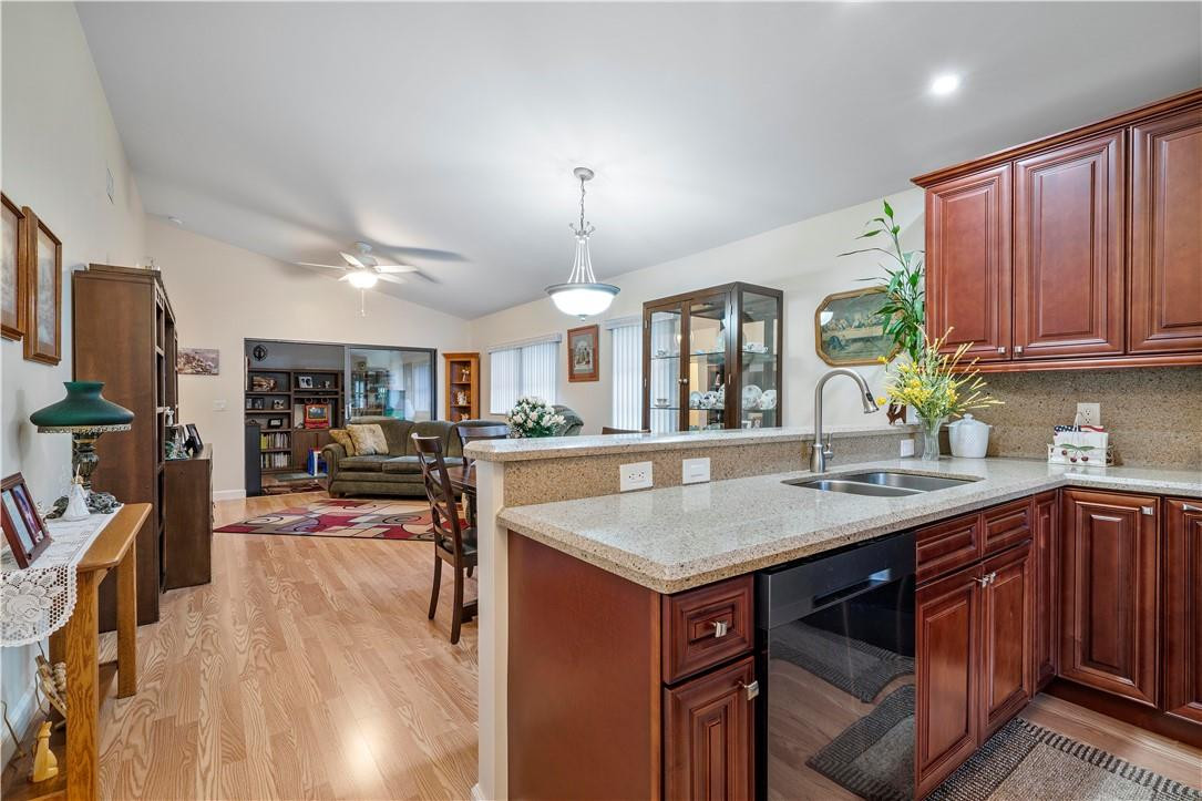 8046 Summerview Terrace Boca Raton, FL 33496 - Photo 7 of 25 a kitchen with stainless steel appliances granite countertop a kitchen island a stove a table and chairs