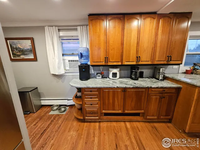 a kitchen with a wooden floor and a sink
