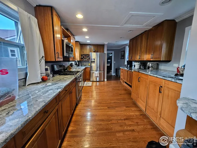 a large kitchen with stainless steel appliances and cabinets