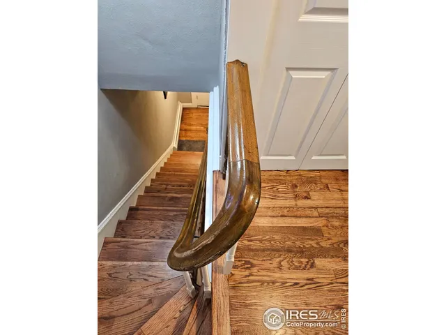 aerial view of a house with wooden deck and backyard