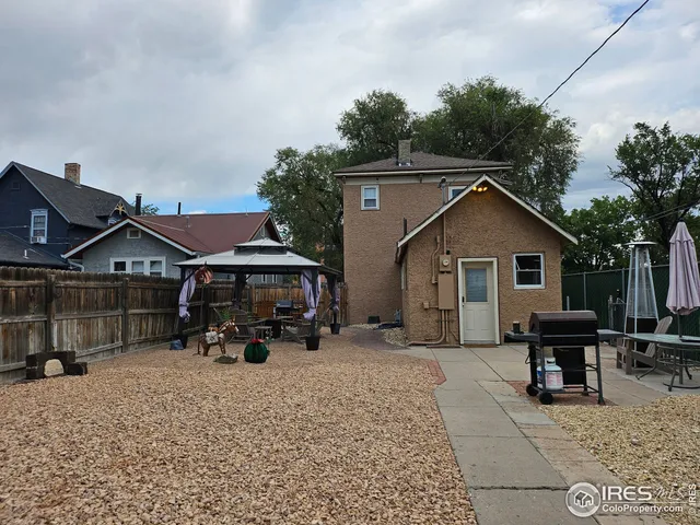 a view of a house with a bench in the patio
