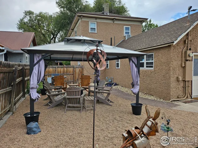 a front view of house with yard outdoor seating and barbeque oven