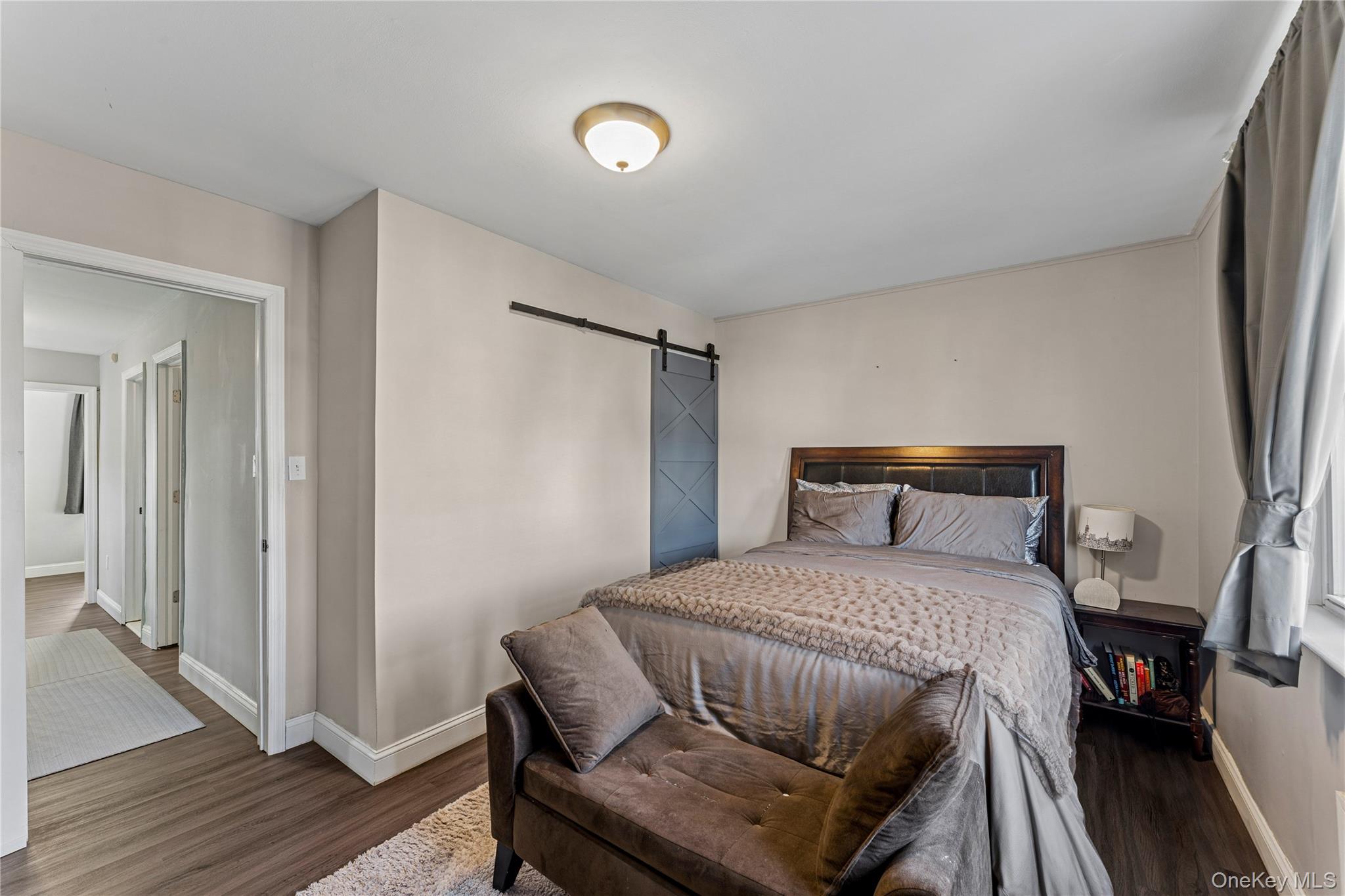 68 Putnam Avenue Valley Stream, NY 11580 - Photo 11 of 23 a bedroom with a bed and wooden floor