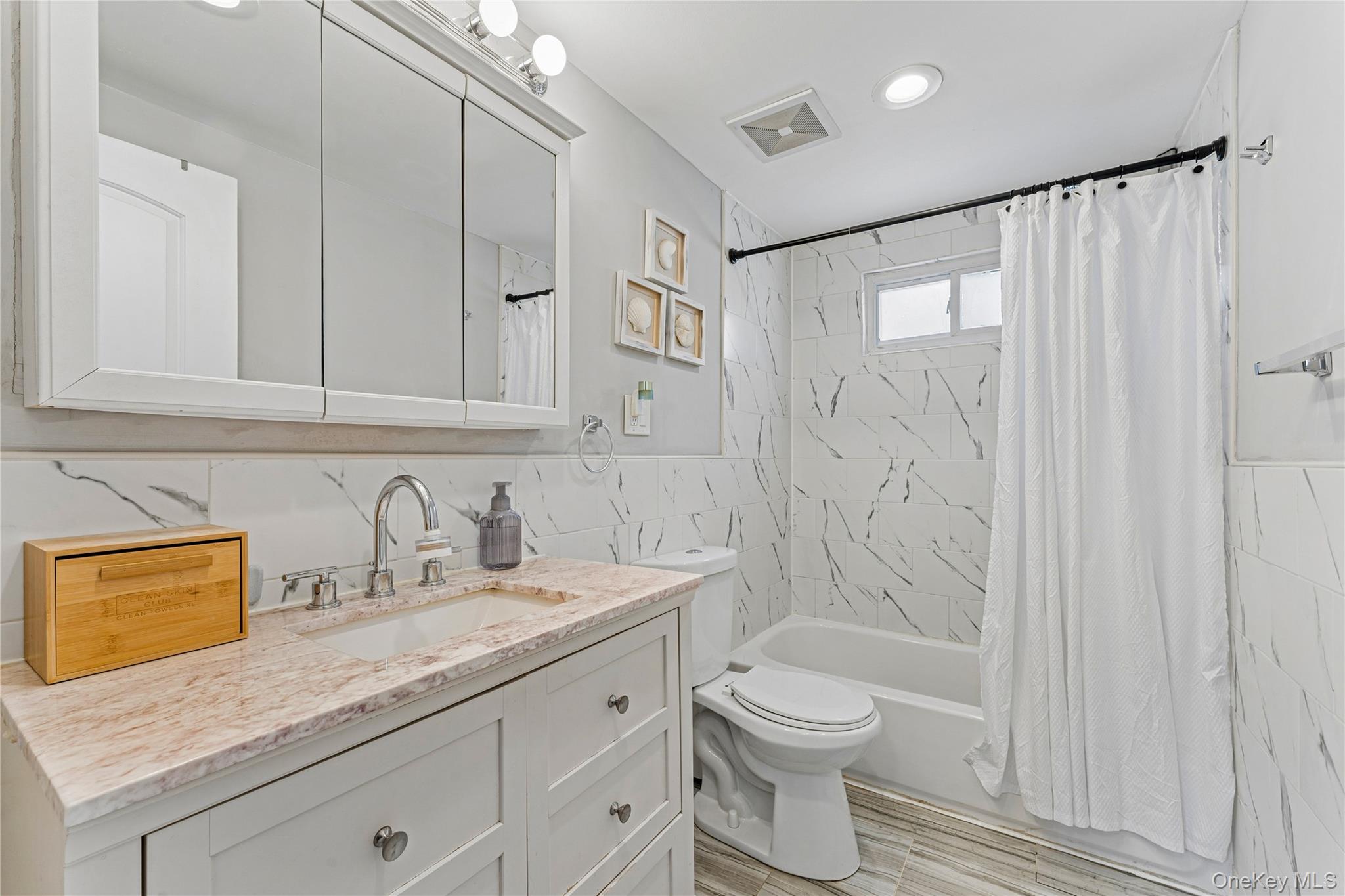 68 Putnam Avenue Valley Stream, NY 11580 - Photo 13 of 23 a bathroom with a granite countertop sink toilet and shower