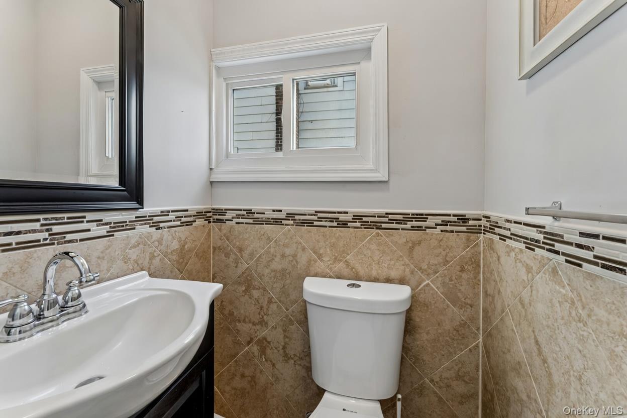68 Putnam Avenue Valley Stream, NY 11580 - Photo 9 of 23 a bathroom with a sink and a toilet