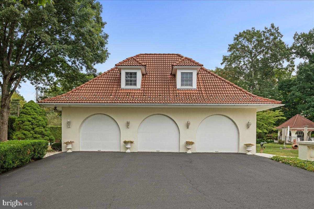 2185 South Easton Road Doylestown, PA 18901 - Photo 13 of 62 a front view of a house with a garden and garage