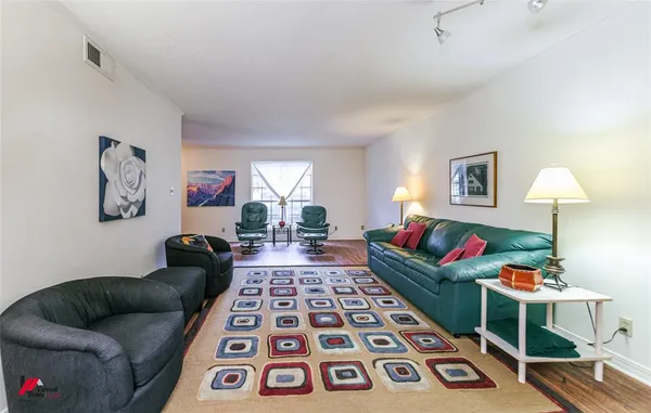 a living room with furniture and a rug