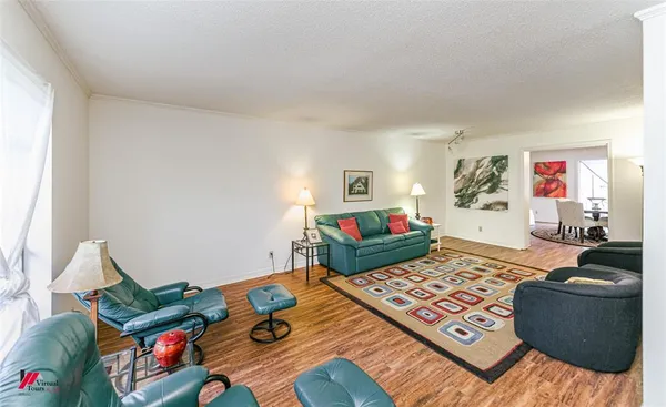 a bedroom with furniture and a wooden floor