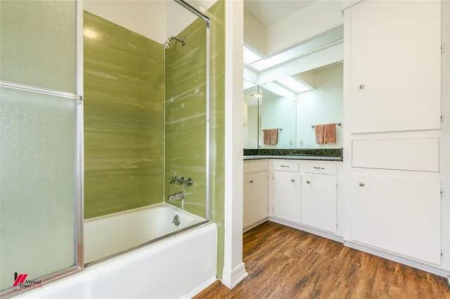 a bathroom with a bathtub and shower