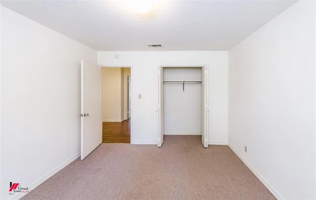 a view of a chair and table in backyard of the house