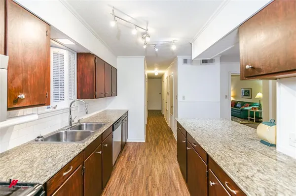 a kitchen with granite countertop kitchen island a sink appliances and a counter space