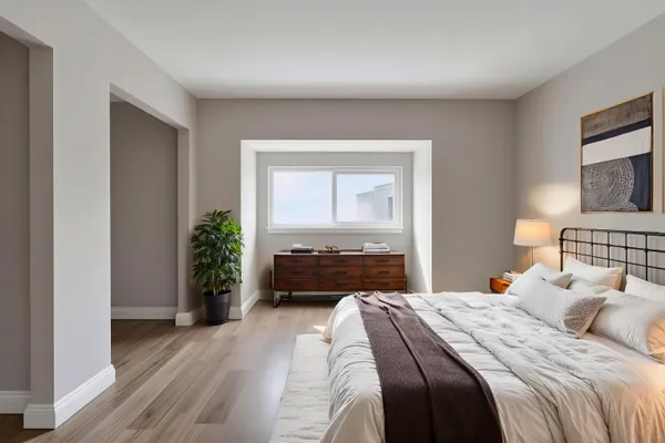 a bedroom with a bed and a flat screen tv