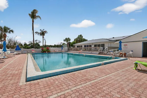 a view of a chairs and tables on the balcony