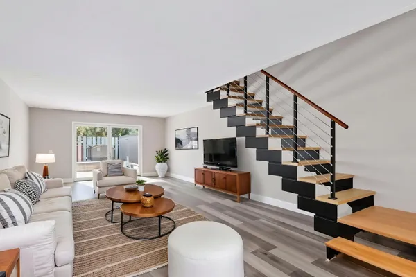 a living room with furniture and wooden floor