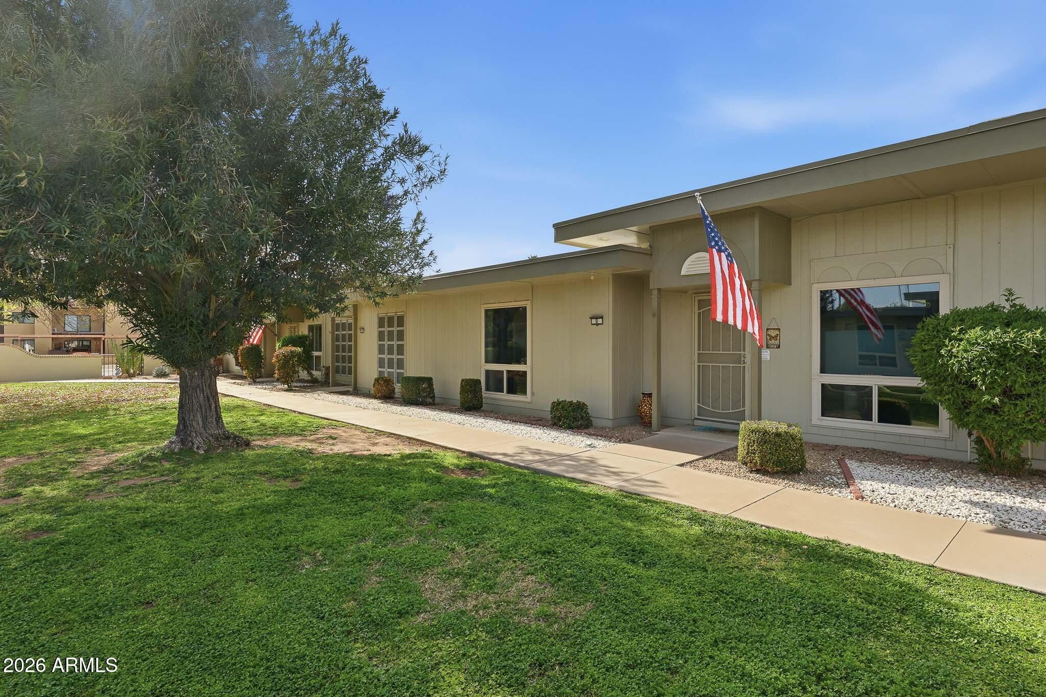 9970 West Royal Oak Road, Unit Q Sun City, AZ 85351 - Photo 10 of 38 a backyard of a house with table and chairs