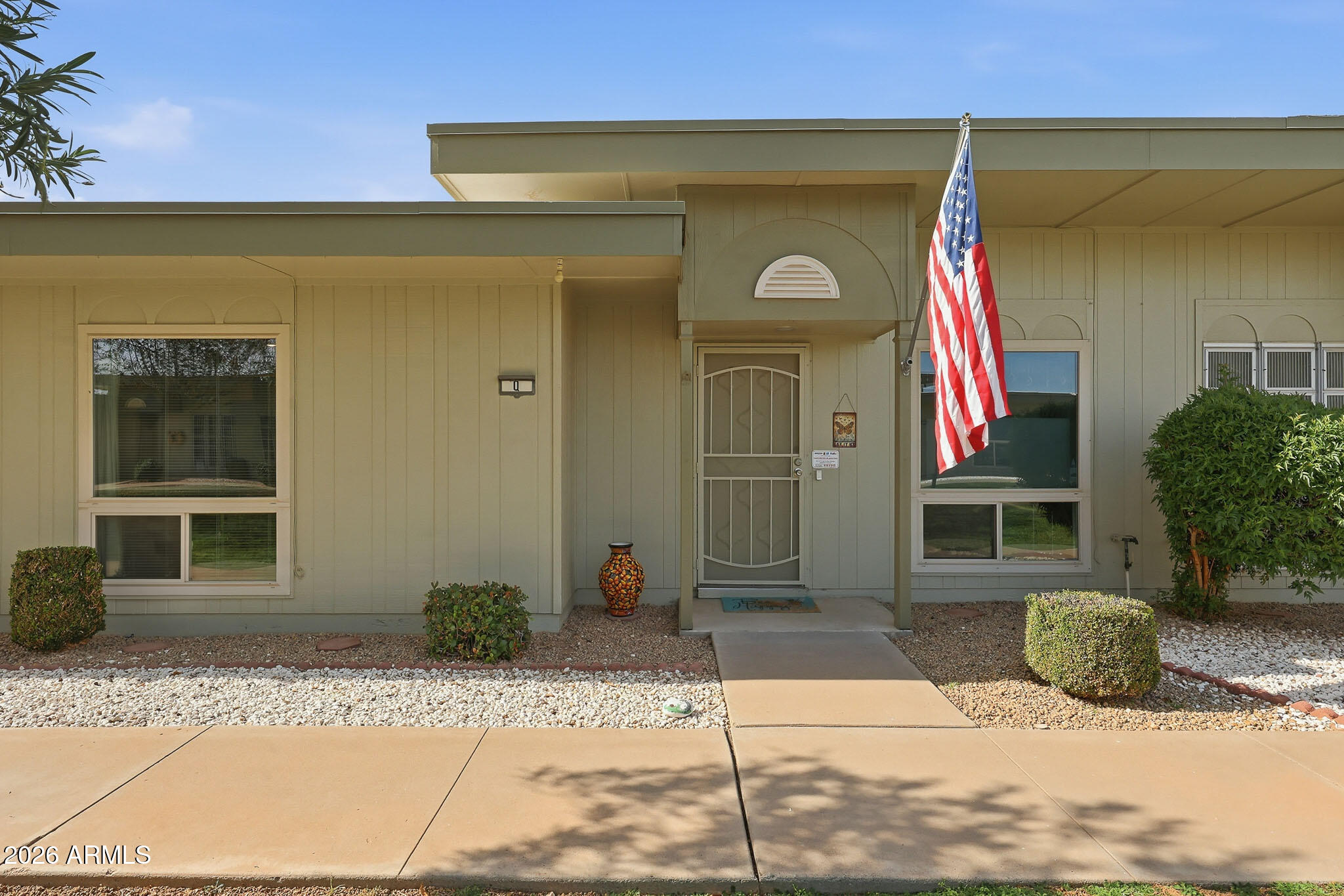 9970 West Royal Oak Road, Unit Q Sun City, AZ 85351 - Photo 12 of 38 a front view of a house with a yard and garage