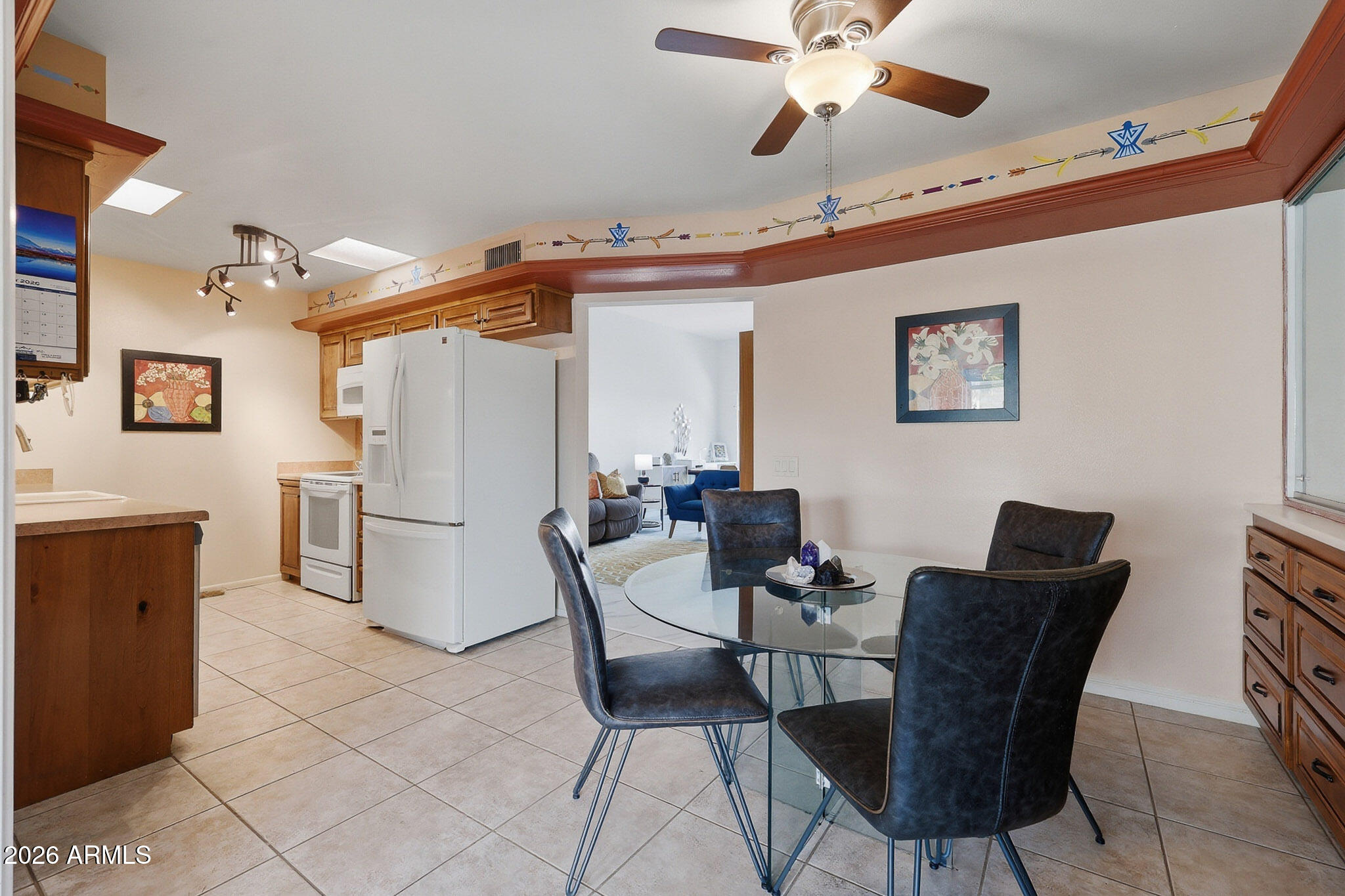 9970 West Royal Oak Road, Unit Q Sun City, AZ 85351 - Photo 18 of 38 a dining room with furniture and a chandelier fan