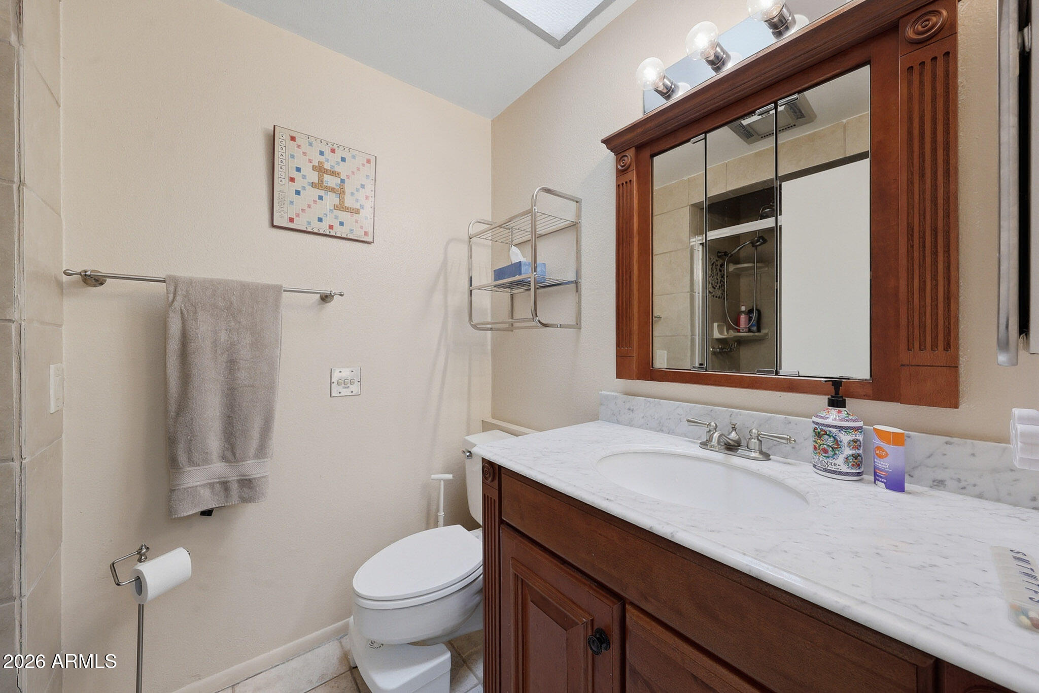 9970 West Royal Oak Road, Unit Q Sun City, AZ 85351 - Photo 20 of 38 a bathroom with a granite countertop sink a toilet and a mirror