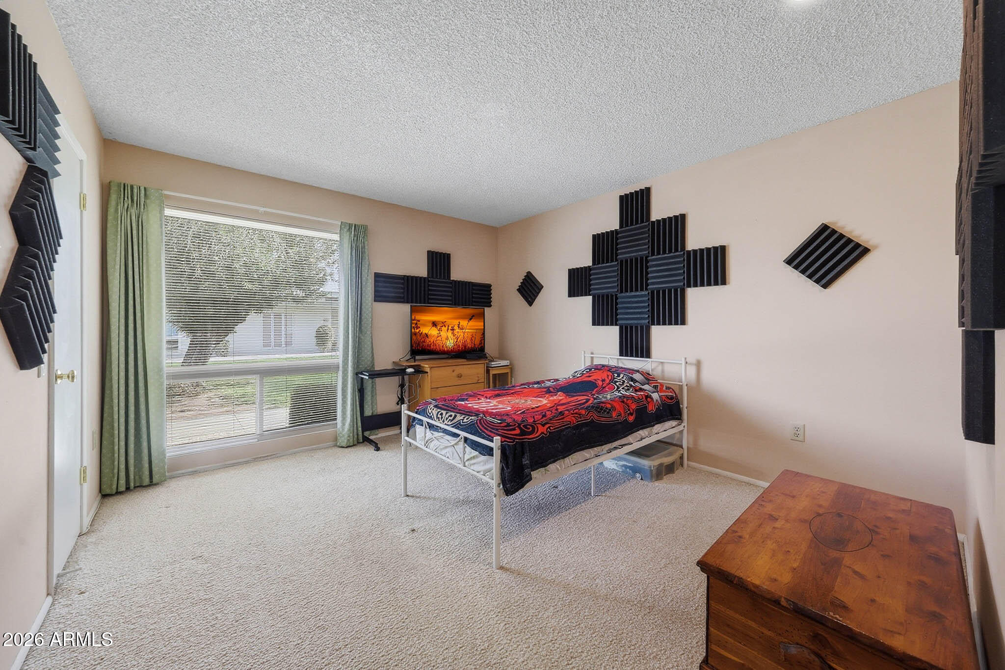 9970 West Royal Oak Road, Unit Q Sun City, AZ 85351 - Photo 21 of 38 a bedroom with furniture and a flat screen tv