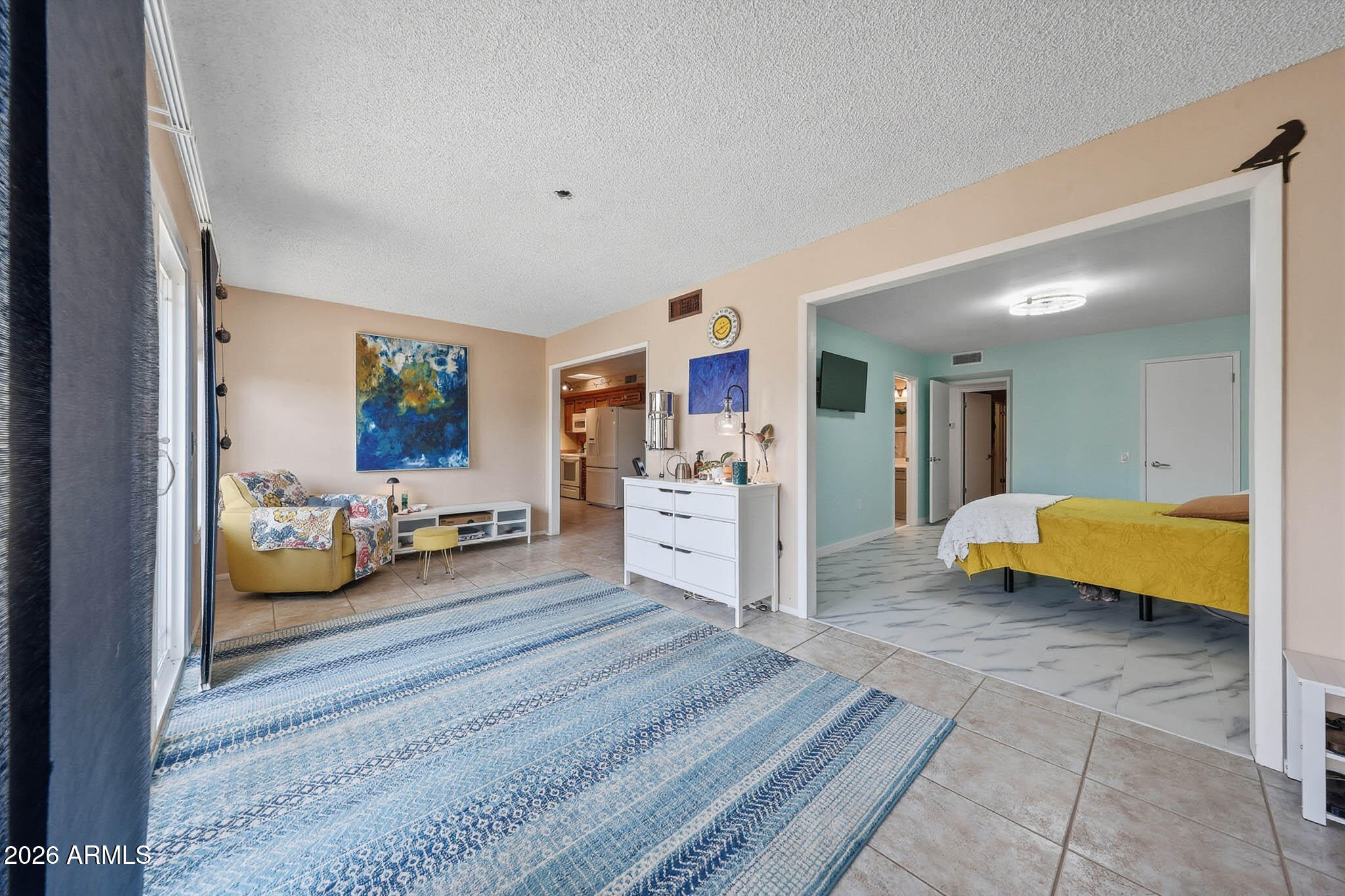 9970 West Royal Oak Road, Unit Q Sun City, AZ 85351 - Photo 27 of 38 a spacious bedroom with a bed and a couch