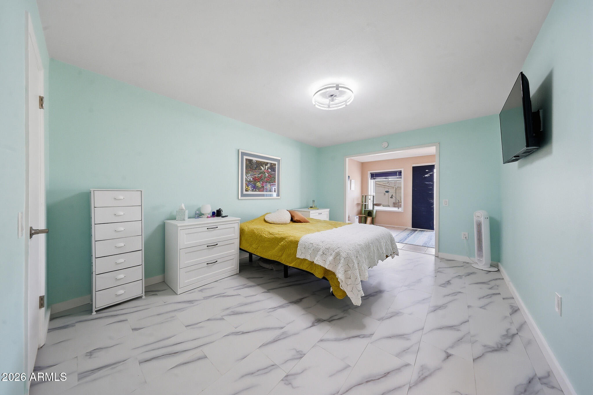 9970 West Royal Oak Road, Unit Q Sun City, AZ 85351 - Photo 29 of 38 a spacious bedroom with a large bed and a flat screen tv