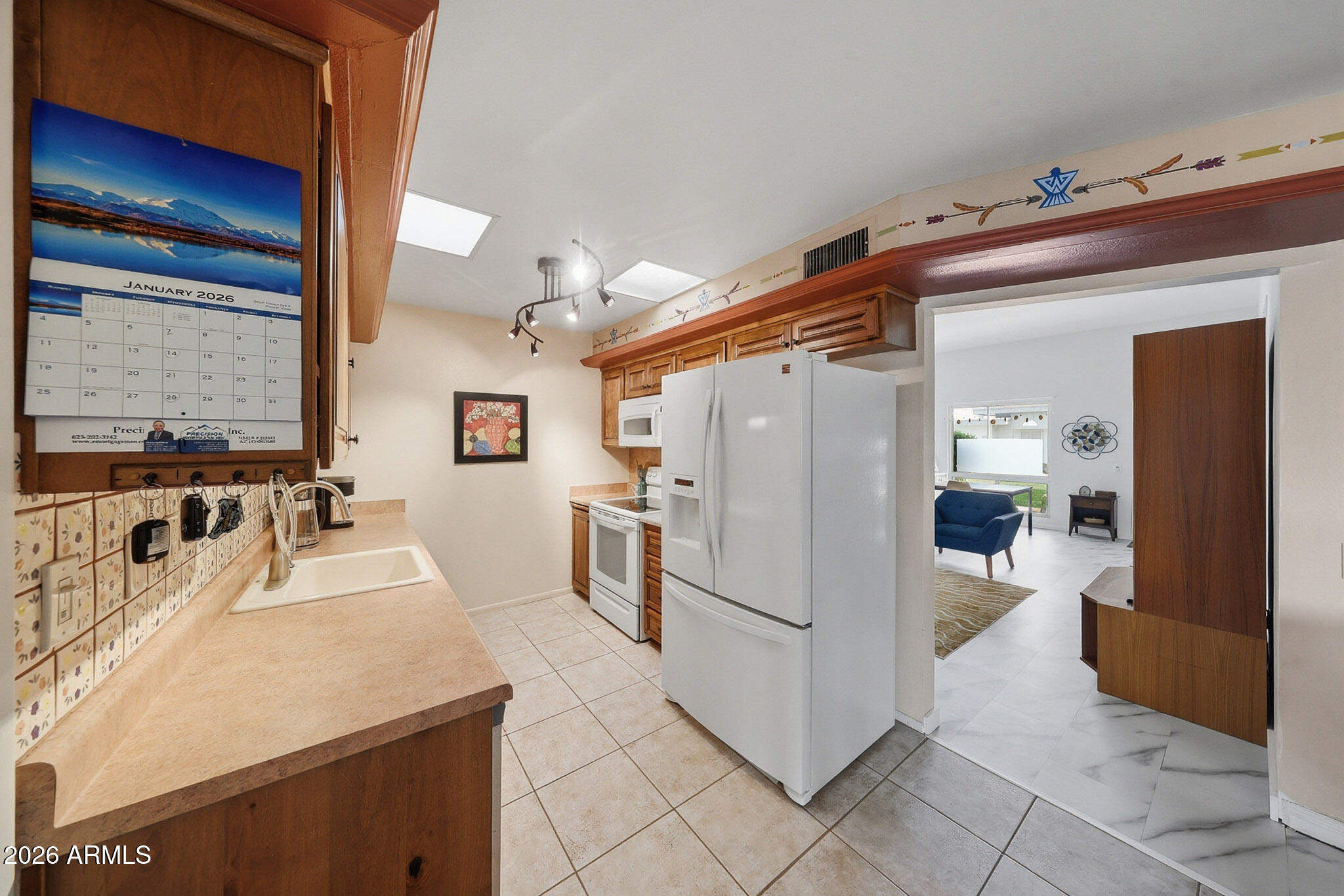 9970 West Royal Oak Road, Unit Q Sun City, AZ 85351 - Photo 2 of 38 a kitchen with a refrigerator and microwave