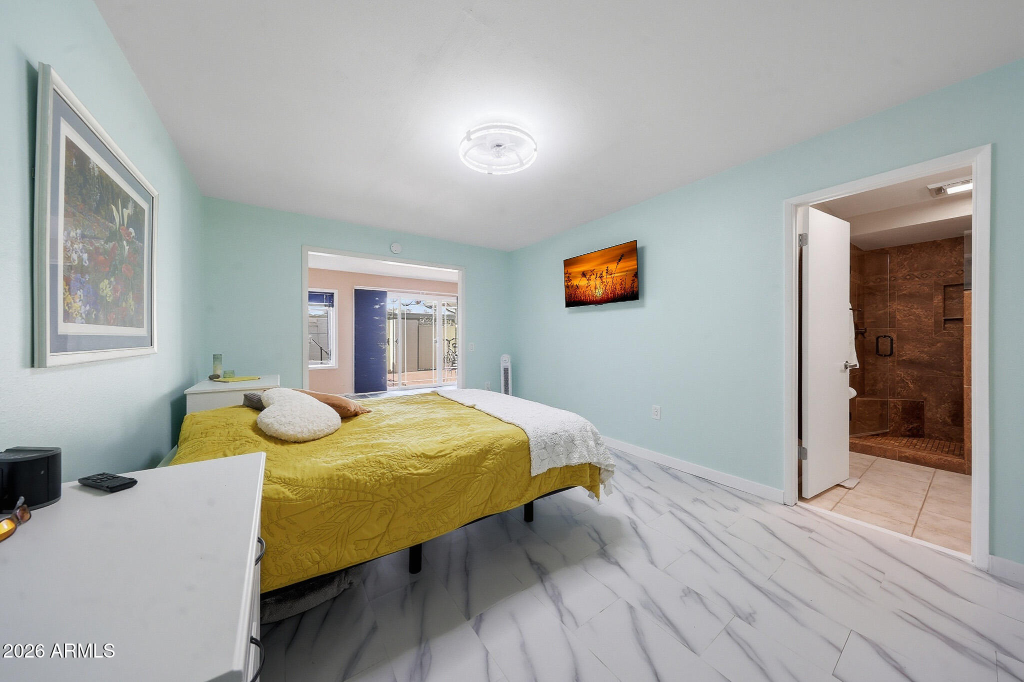 9970 West Royal Oak Road, Unit Q Sun City, AZ 85351 - Photo 30 of 38 a bedroom with a bed and wooden floor