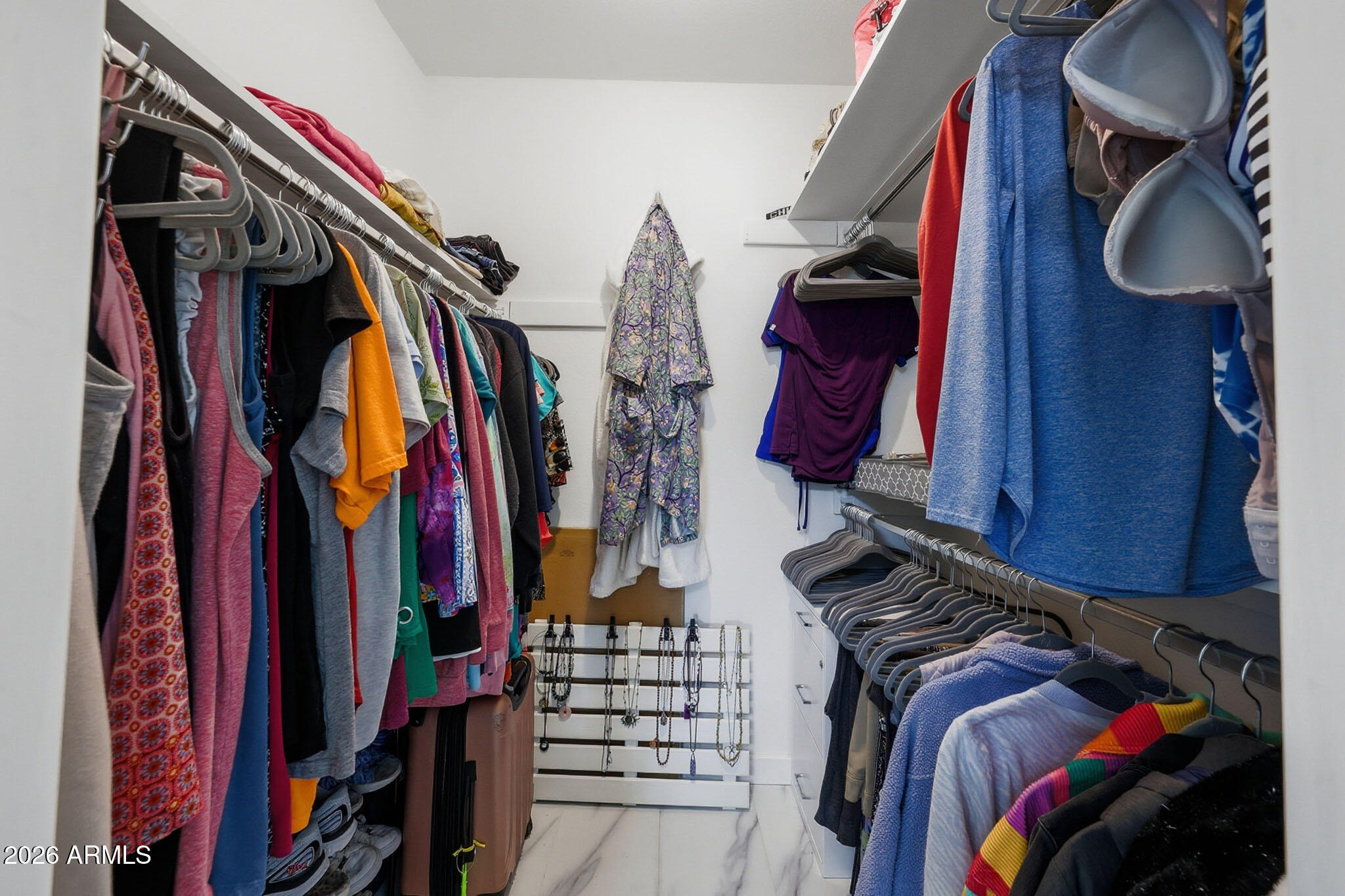 9970 West Royal Oak Road, Unit Q Sun City, AZ 85351 - Photo 31 of 38 a view of walk in closet with clothes and shoes