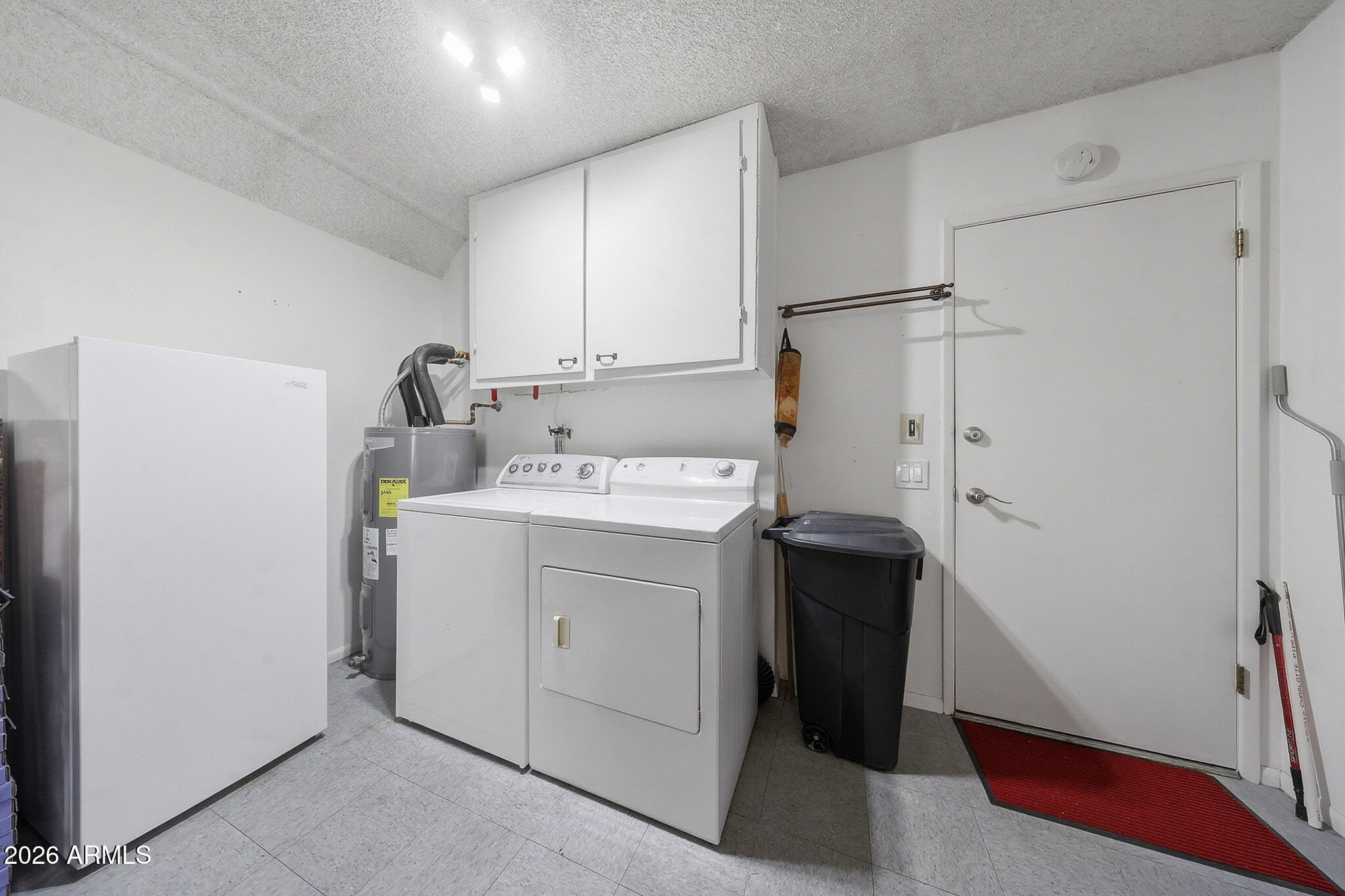 9970 West Royal Oak Road, Unit Q Sun City, AZ 85351 - Photo 32 of 38 a utility room with cabinets washer and dryer