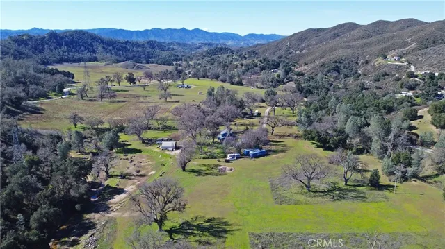 a view of a house with a mountain and a yard