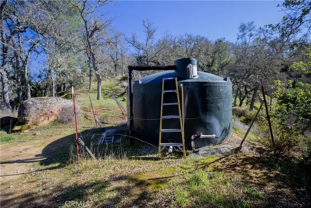 a view of backyard with wooden fence