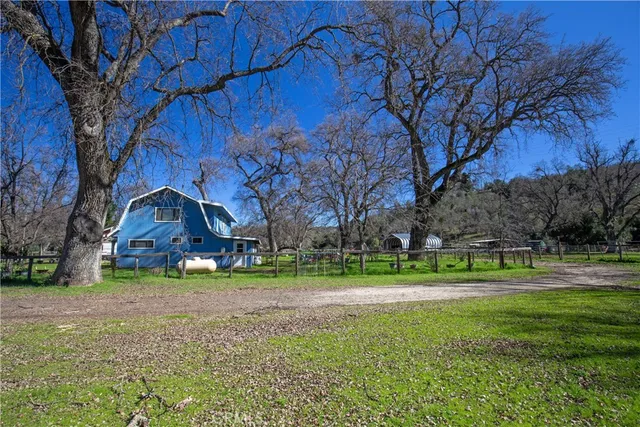 a backyard of a house with outdoor seating and trees
