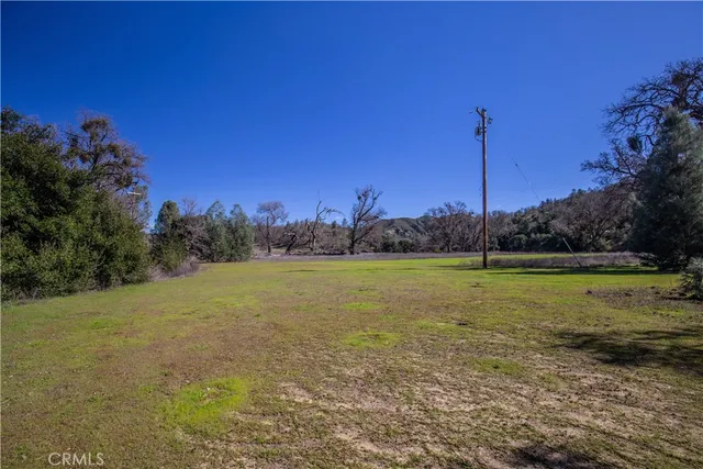 a view of a field with an ocean view