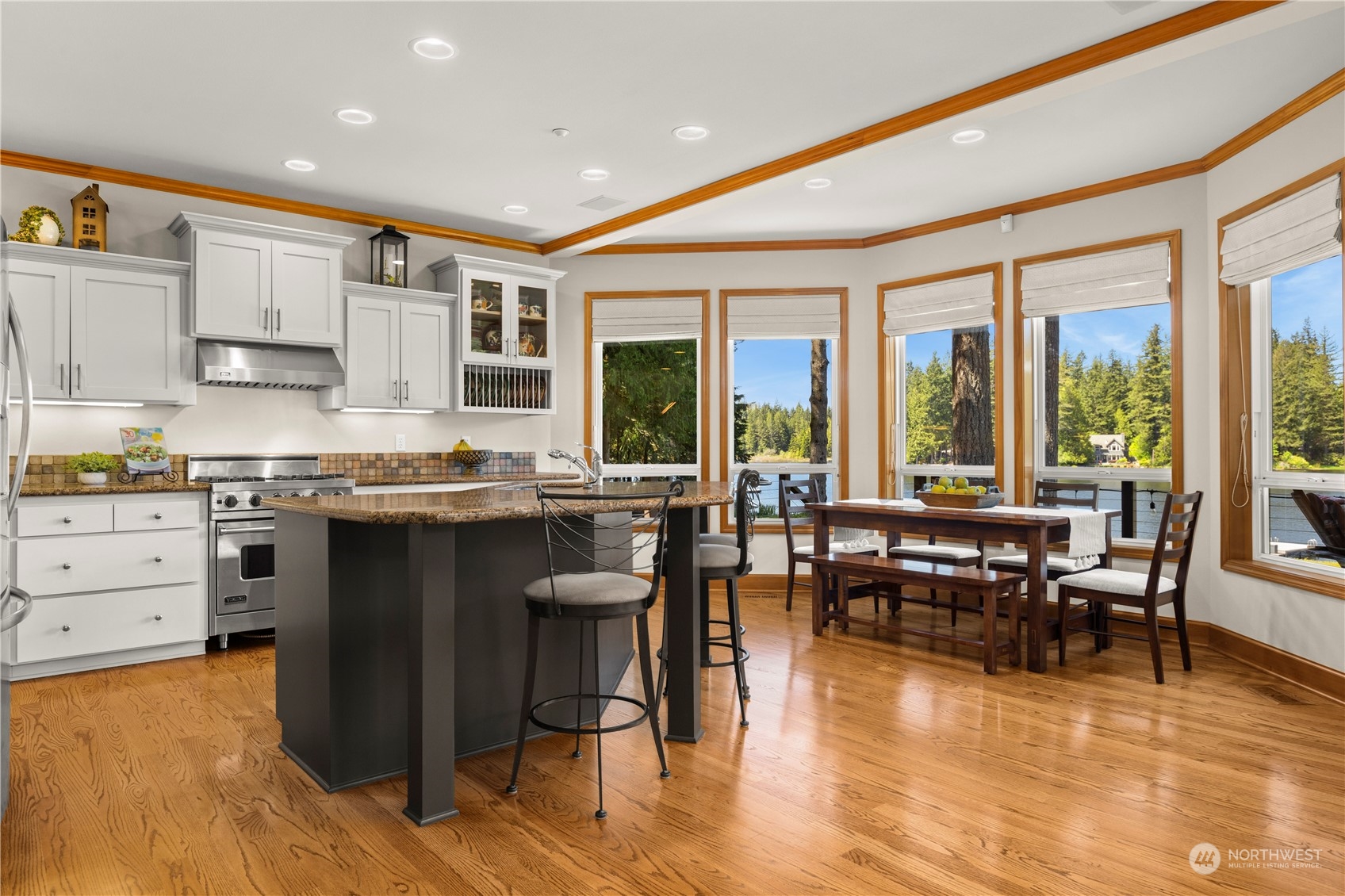 7805 Lake Alice Road Southeast Fall City, WA 98024 - Photo 10 of 32 a kitchen with stainless steel appliances granite countertop a stove top oven a sink a dining table and chairs with wooden floor