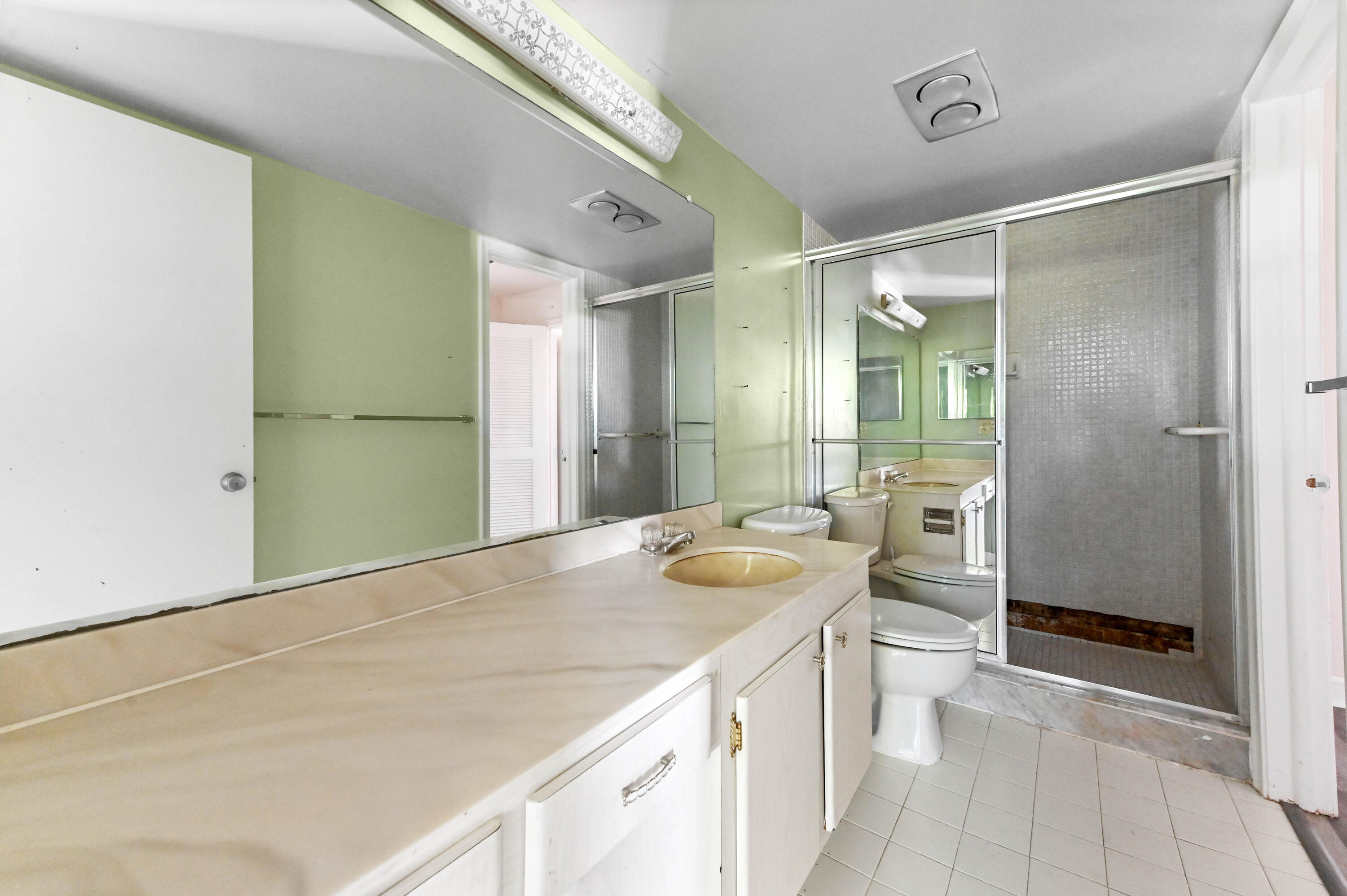 4080 Tivoli Court, Unit 202 Lake Worth, FL 33467 - Photo 17 of 28 a bathroom with a granite countertop sink and a mirror