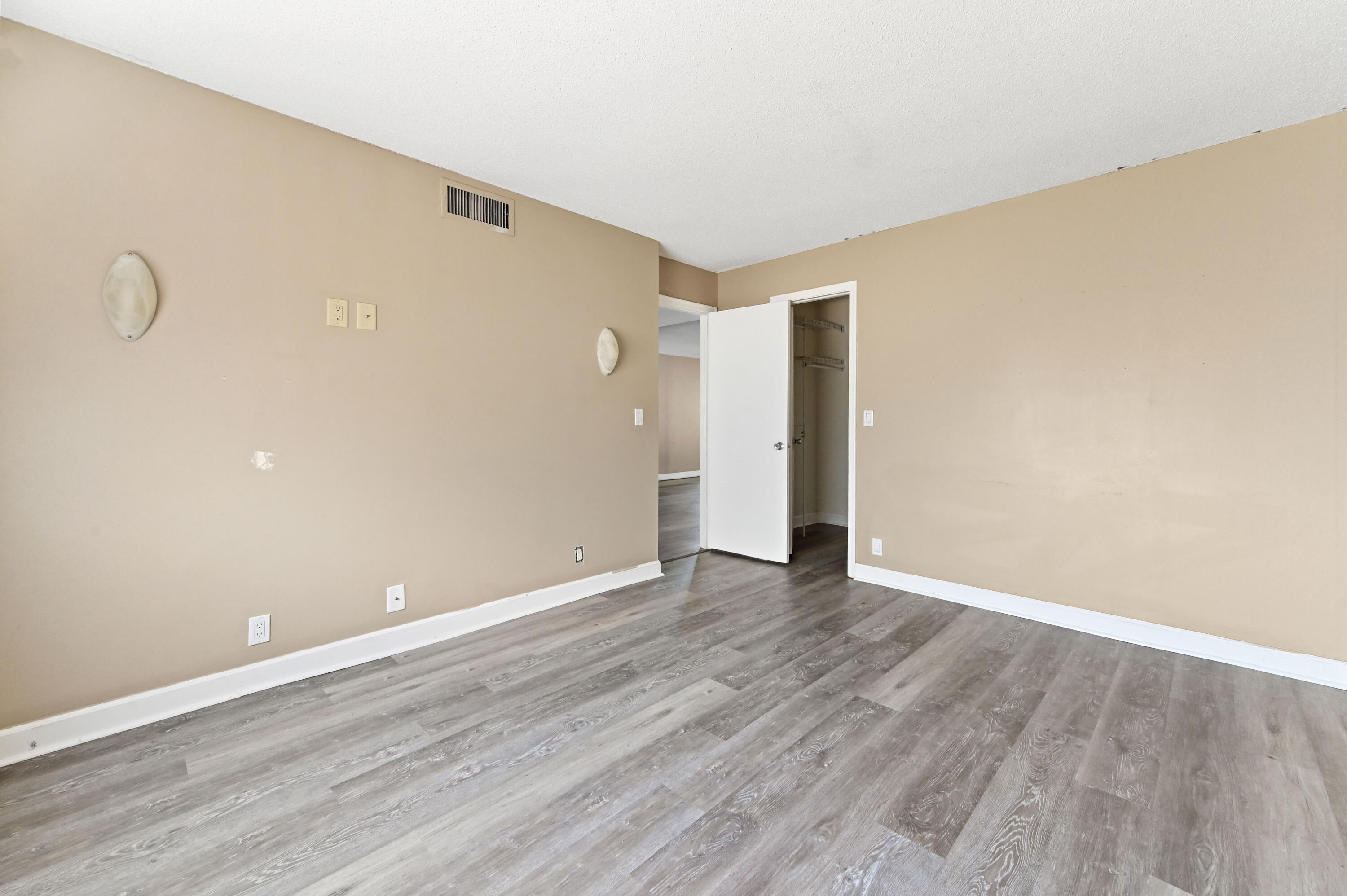 4080 Tivoli Court, Unit 202 Lake Worth, FL 33467 - Photo 20 of 28 a view of an empty room with wooden floor