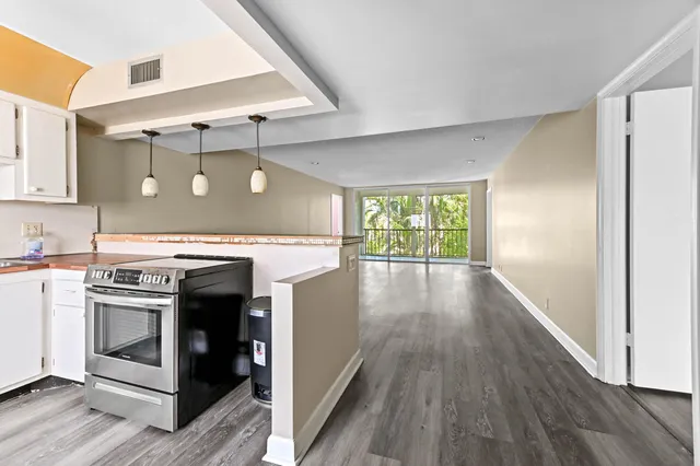 a kitchen with a stove top oven and sink