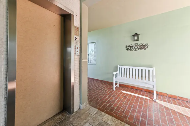 a view of a hallway with wooden floor and a gate