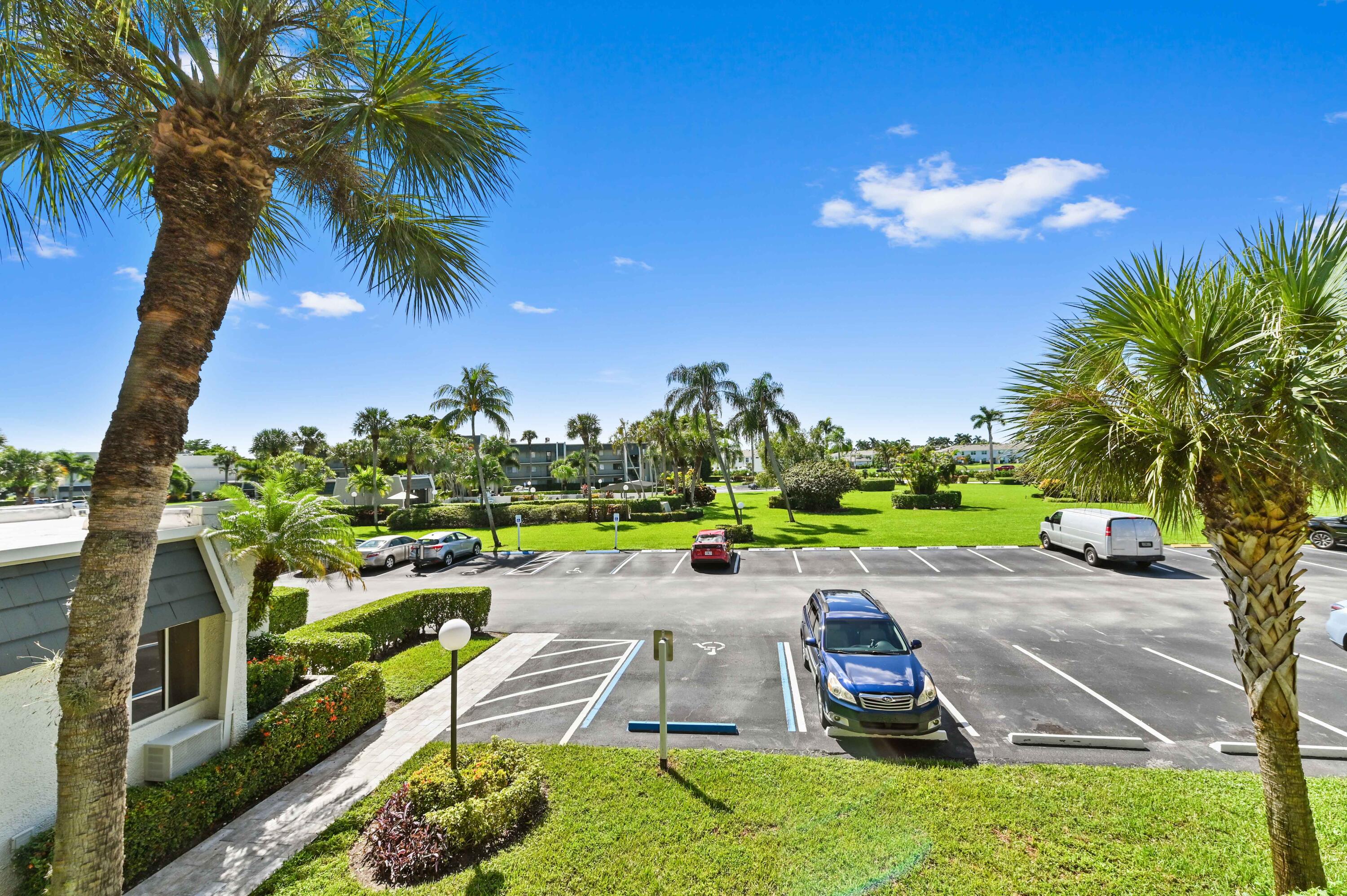 4080 Tivoli Court, Unit 202 Lake Worth, FL 33467 - Photo 27 of 28 a swimming pool with outdoor seating and yard