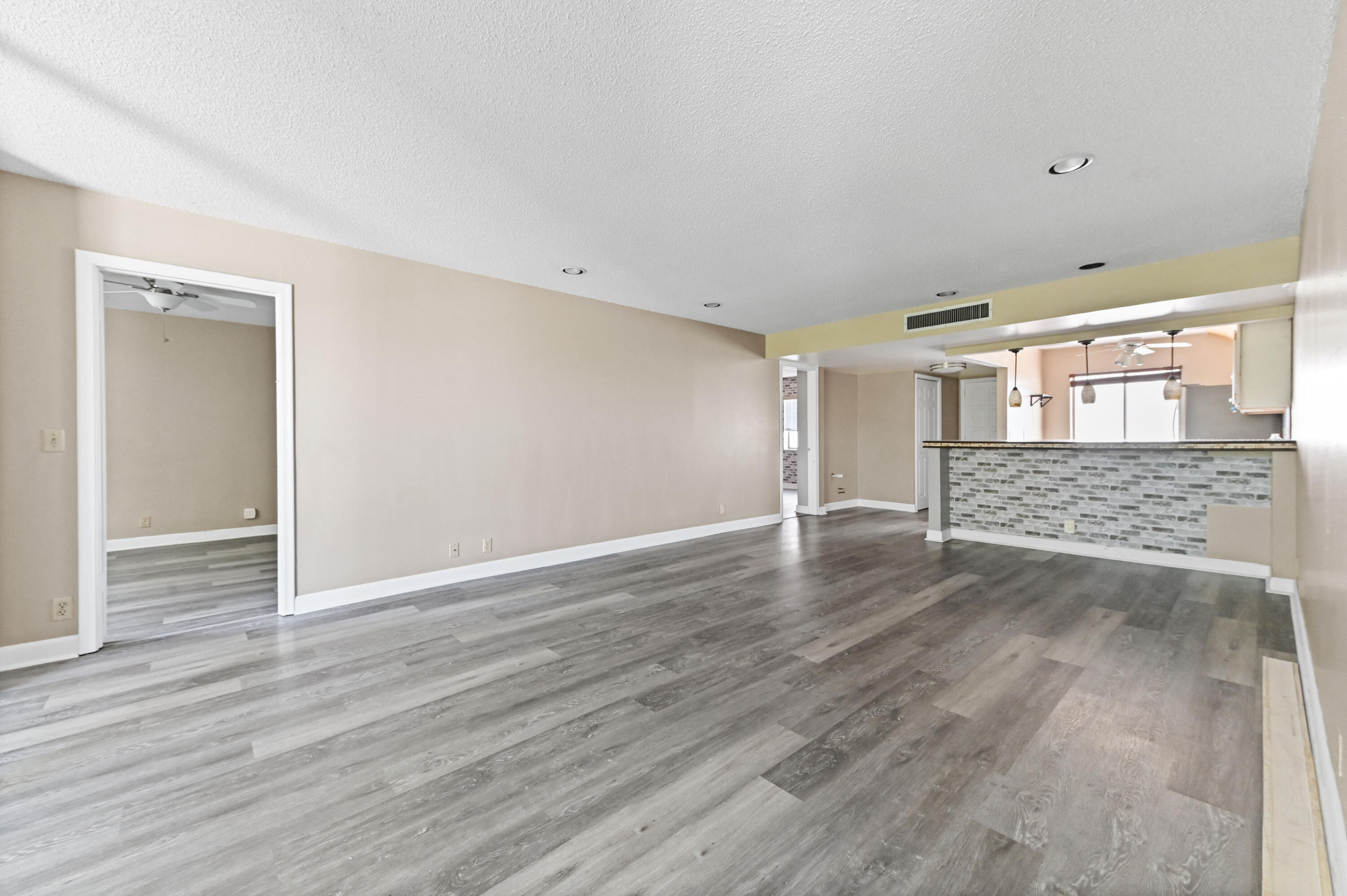 4080 Tivoli Court, Unit 202 Lake Worth, FL 33467 - Photo 9 of 28 a view of an empty room with wooden floor and entryway