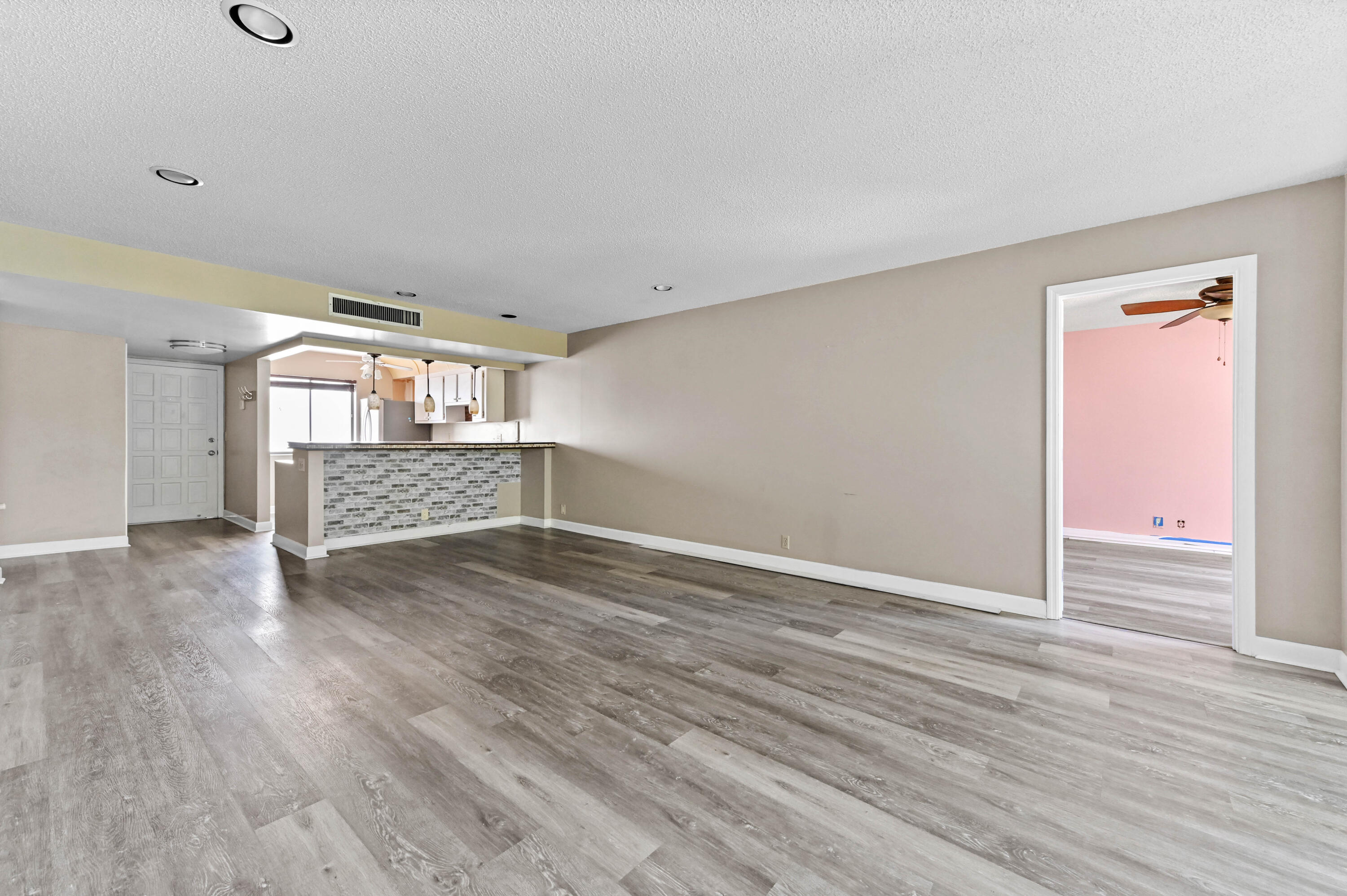 4080 Tivoli Court, Unit 202 Lake Worth, FL 33467 - Photo 10 of 28 a view of an empty room with wooden floor and a window