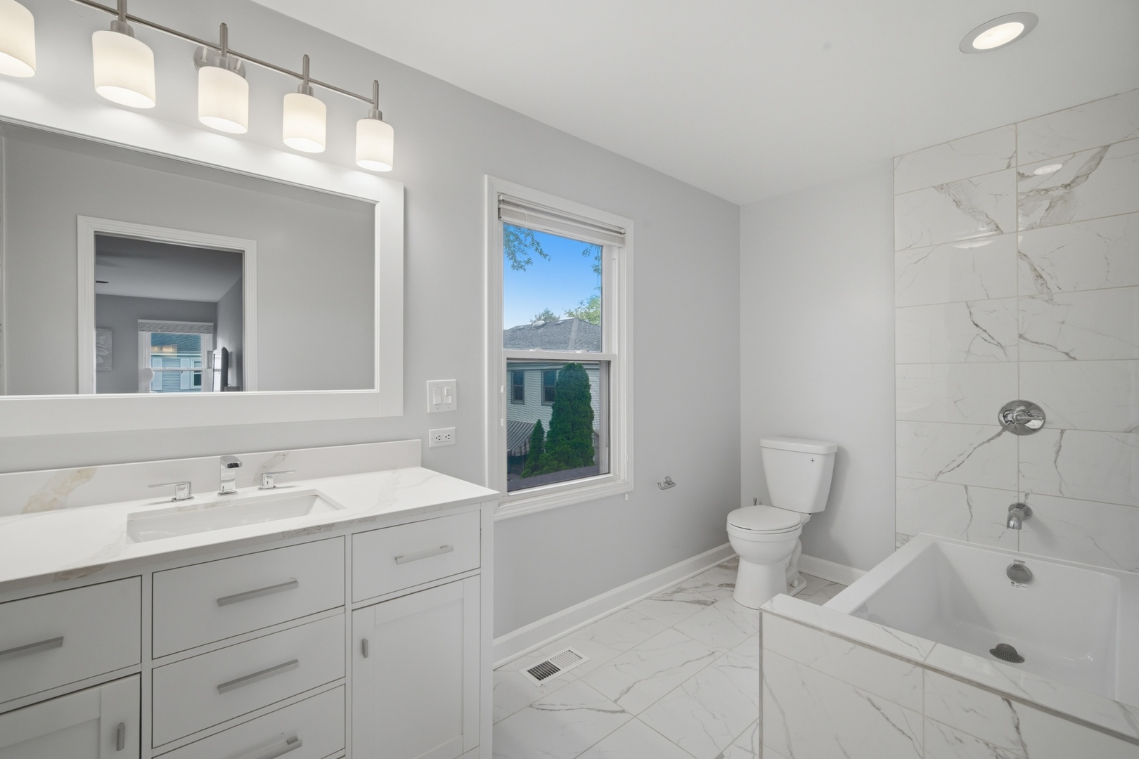 2831 Farmington Road Northbrook, IL 60062 - Photo 19 of 33 a bathroom with a bathtub sink vanity and toilet
