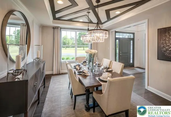 a dining room with furniture a chandelier and wooden floor