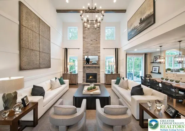 a living room with furniture a chandelier and a fireplace