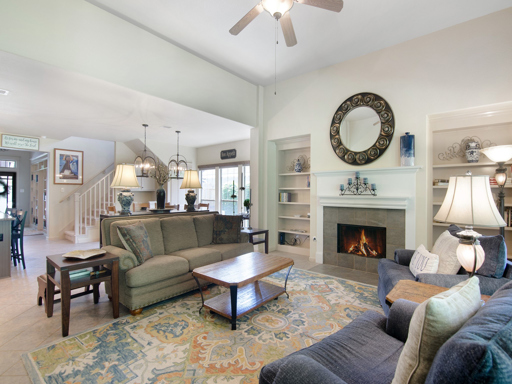 28323 Ryans Ridge Lane Spring, TX 77386 - Photo 26 of 45 Cozy up by the inviting gas-log fireplace featuring a tile surround, crisp white mantel and symmetrical built-in shelving. Perfect for Texas winter weather.