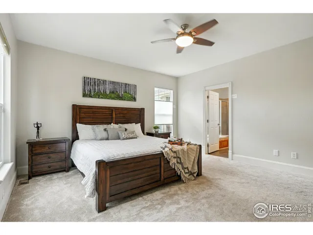 a bedroom with a bed a chandelier and a table