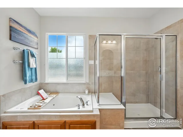a view of bathroom with bathtub and shower