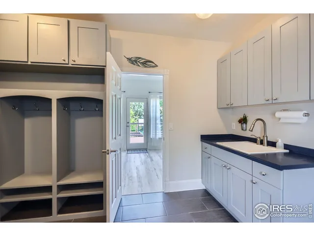 a kitchen with granite countertop a sink and cabinets