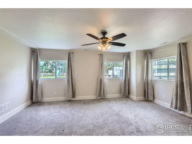 a bathroom with a granite countertop sink toilet mirror and shower